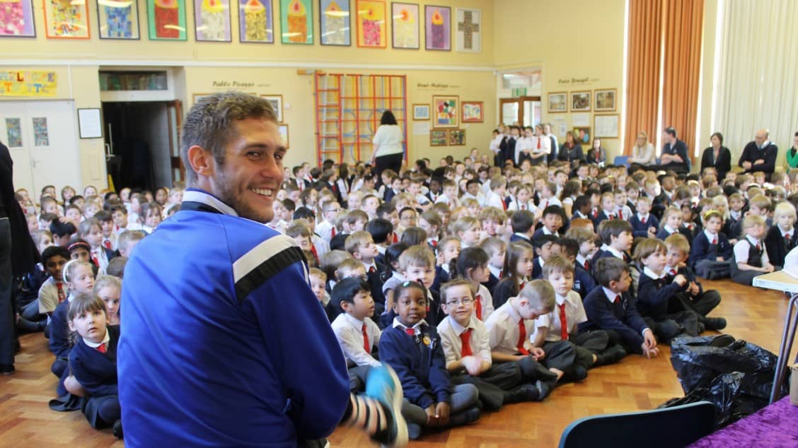 Aldershot Town's Jack Saville with St Joseph's pupils